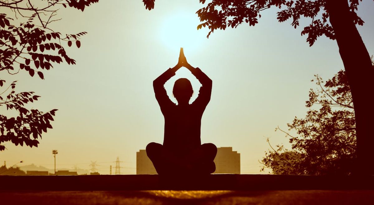 Picture of a person doing yoga outdoors.